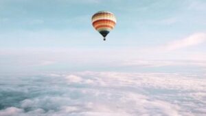 Hot air balloon above clouds
