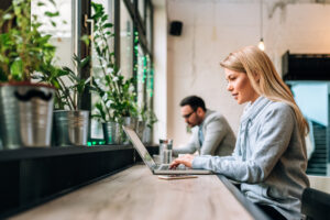 Woman using a laptop in a cafe