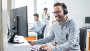 Man on computer using headset