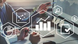 logos of data and statistics hovering over image of hands pointing at computer screen
