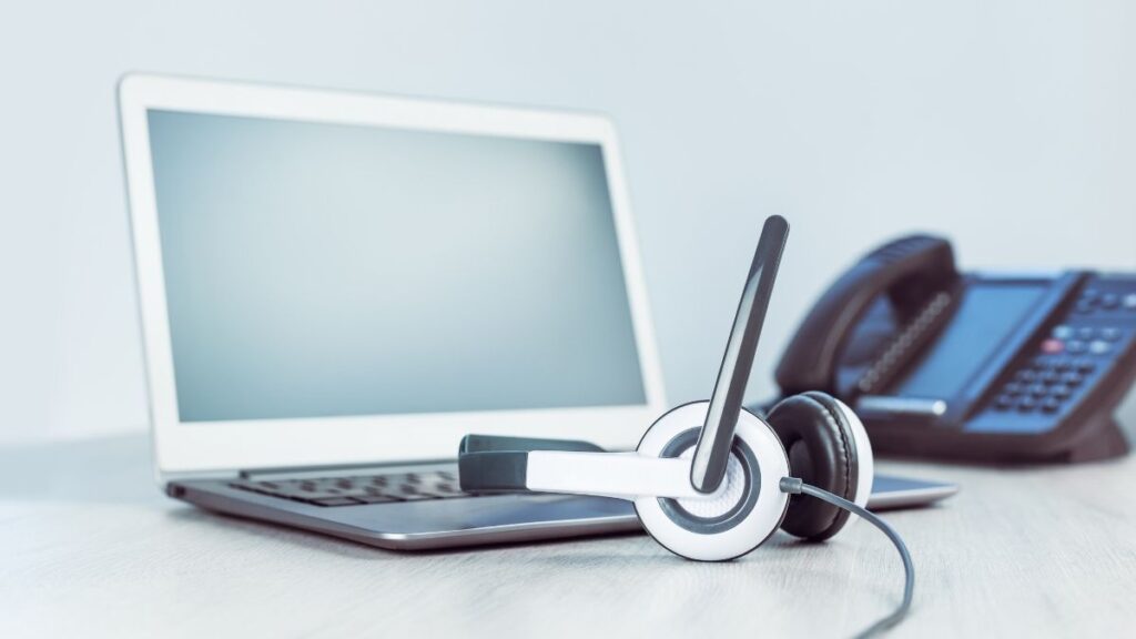 phone, computer, and headset on table