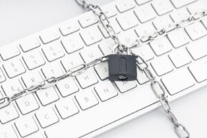 padlock and chain around a mac keyboard