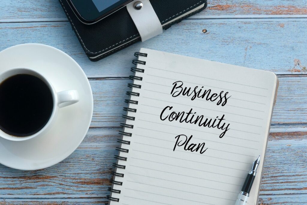 pep and ruled papaer with business continuity plan written on it in cursive text