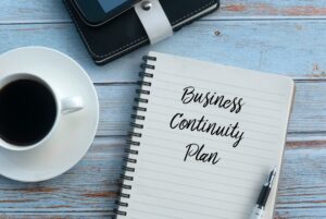 pep and ruled papaer with business continuity plan written on it in cursive text