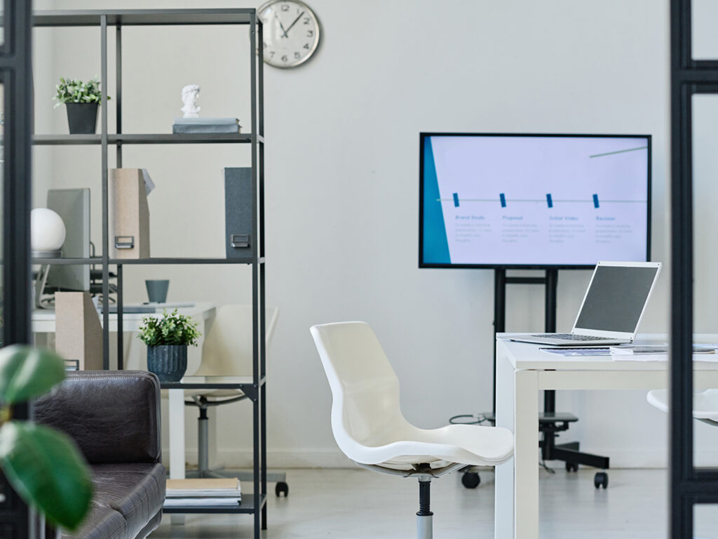 minimalist white office with white laptop on desk